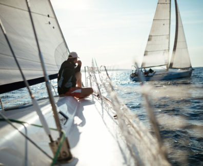 young-handsome-man-relaxing-on-his-sailboat-EA7SBYR_web